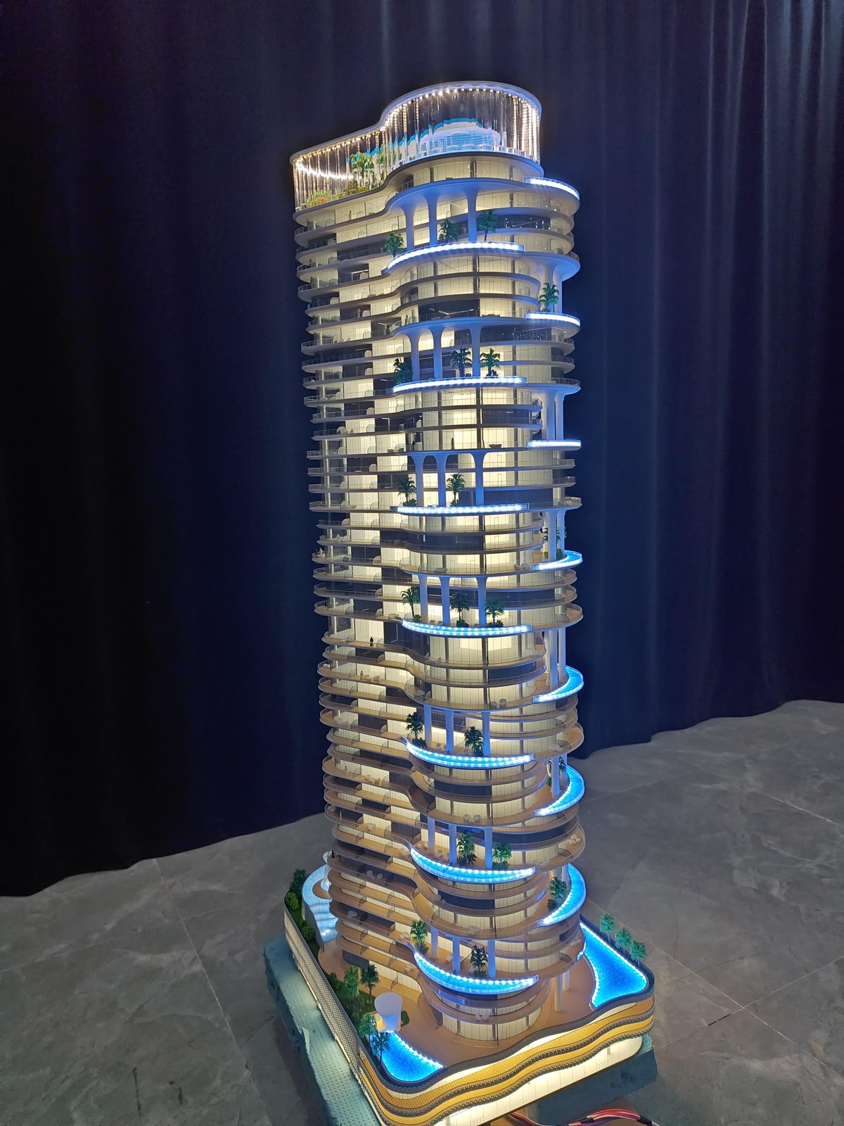 Curved high-rise tower scale model with LED lit balconies